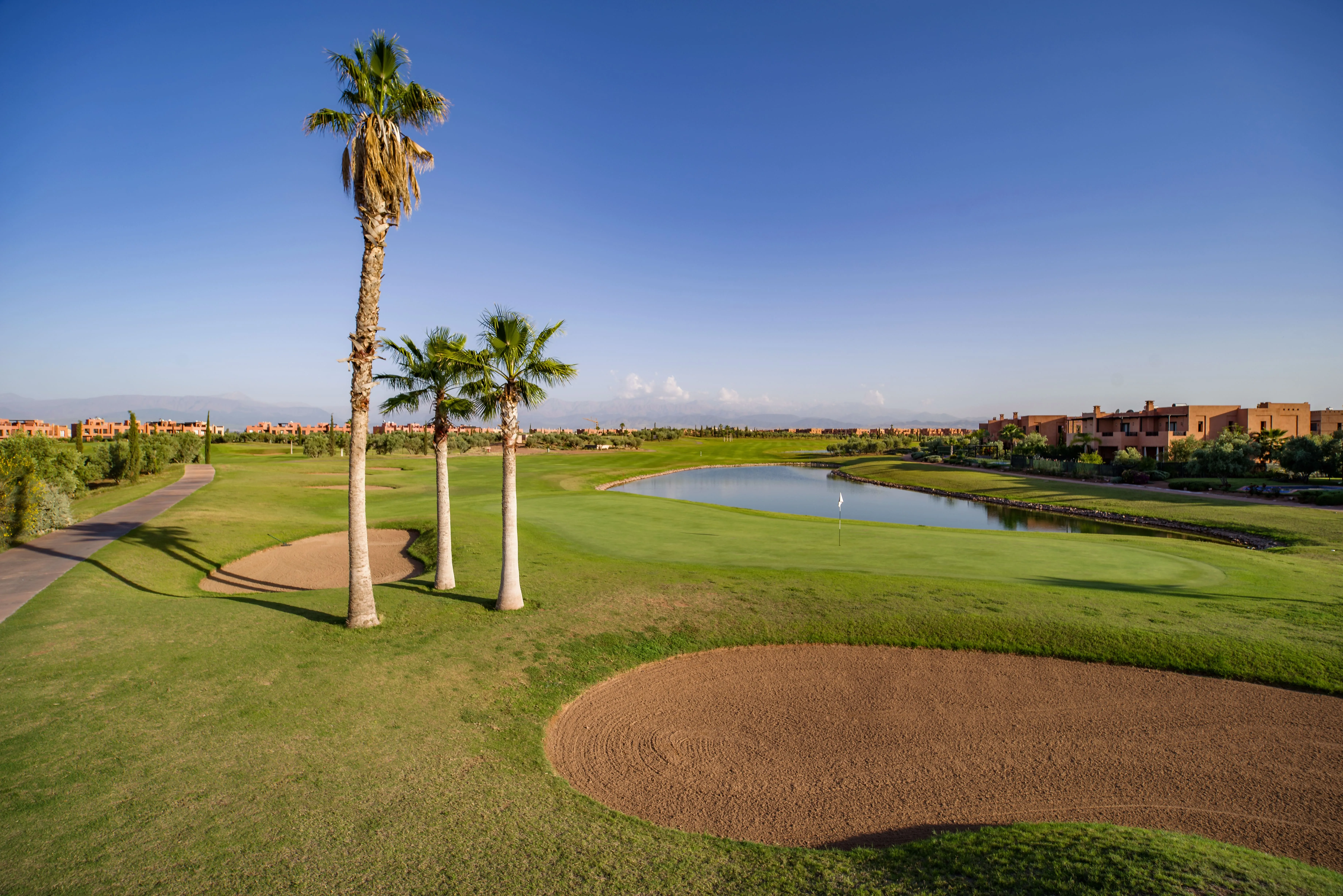 Palm-lined fairway and water hazard at a championship golf course near Marrakech
