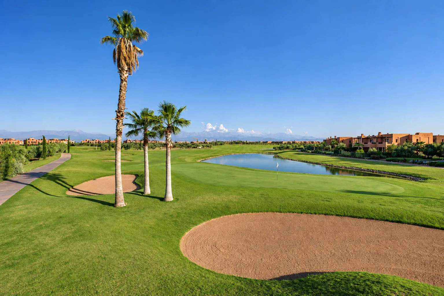 Palm-lined fairway and water hazard at a championship golf course near Marrakech